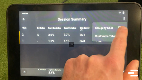 Garmin Approach R50 screen showing session summary with user selecting “Group by Club” to organize shot data by golf club used.